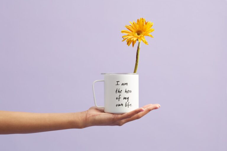 yellow petaled flower in white mug